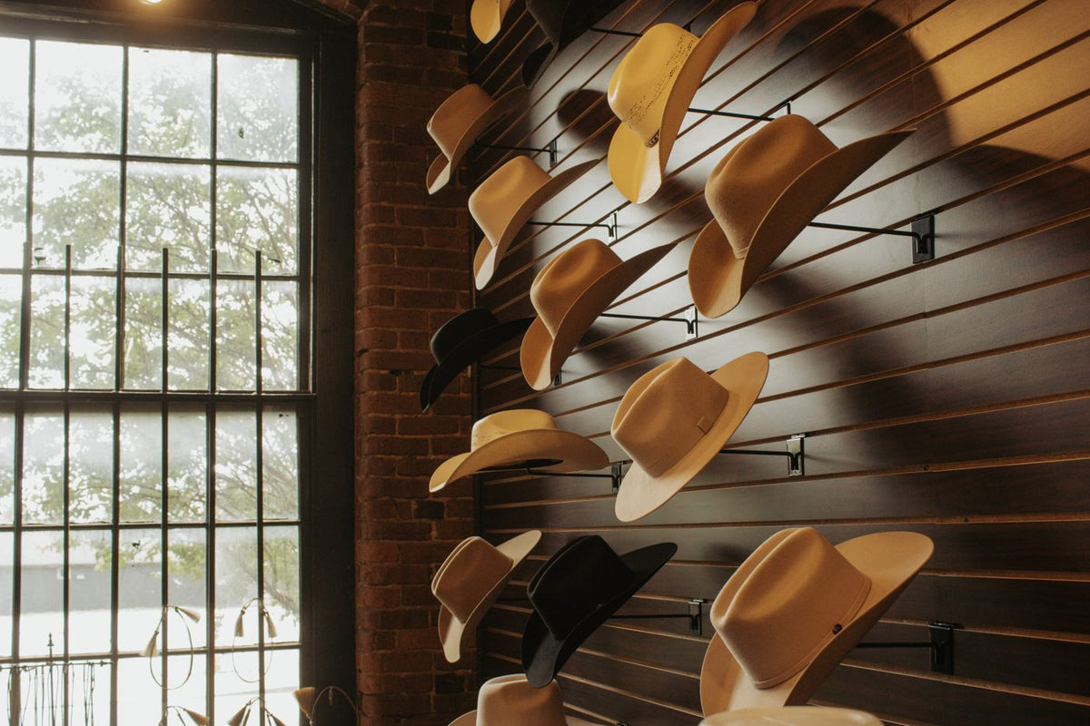 Cowboy hat wall beside the shop window at Steel & Saddle Outfitters, Marathon Village, Nashville