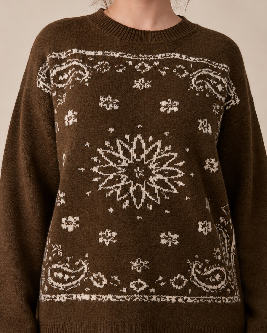 Close-up of the bandana sweater's jacquard knit: cream paisley corners and a starburst at the center