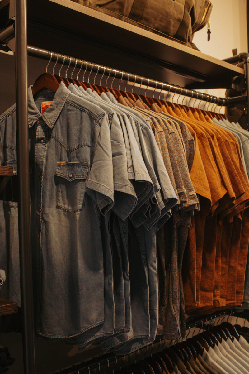 Clothing rack with various shirts hanging on it