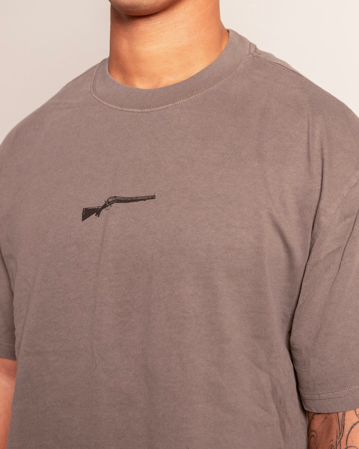 Lever Action Tee in faded grey, close-up of the lever action rifle chest print