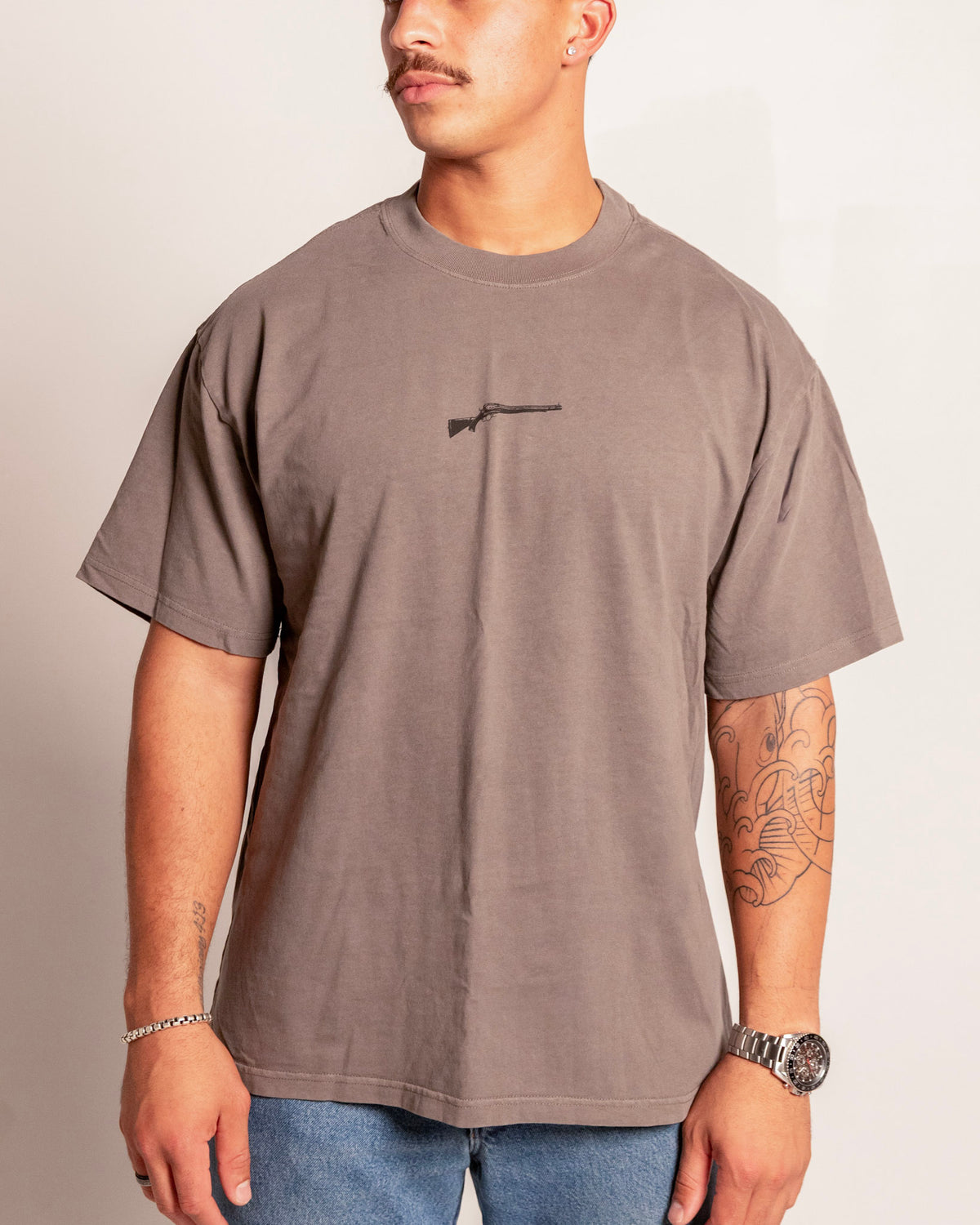 Lever Action Tee in faded grey on model, front view with the lever action rifle chest print