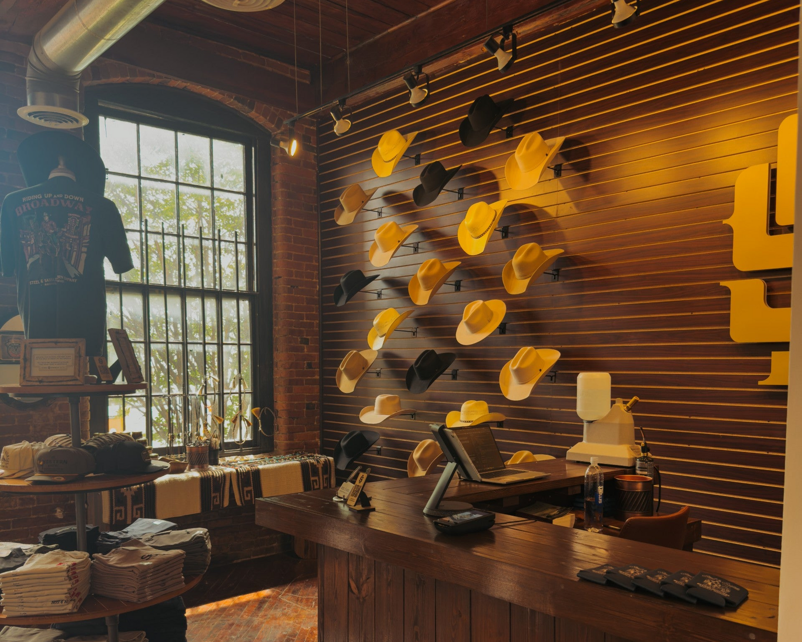 Interior of a Steel & Saddle with a wall display of hats and a counter.